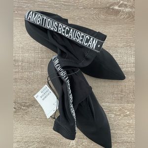 Size 7 brand new woman’s booties, black with writing at the back of the boots.
